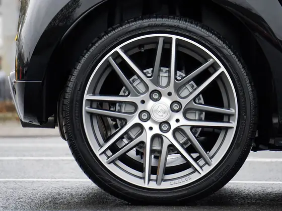 Close view of an alloy road wheel and tyre sidewall