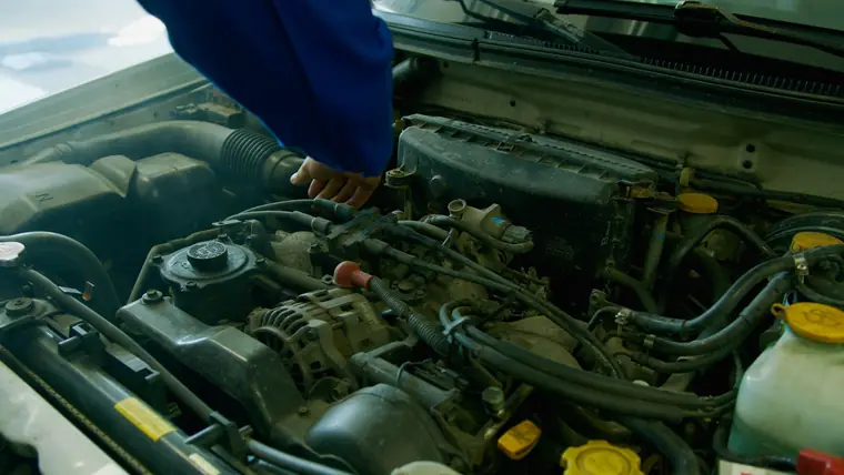 A technician working on a vehicle in a service bay